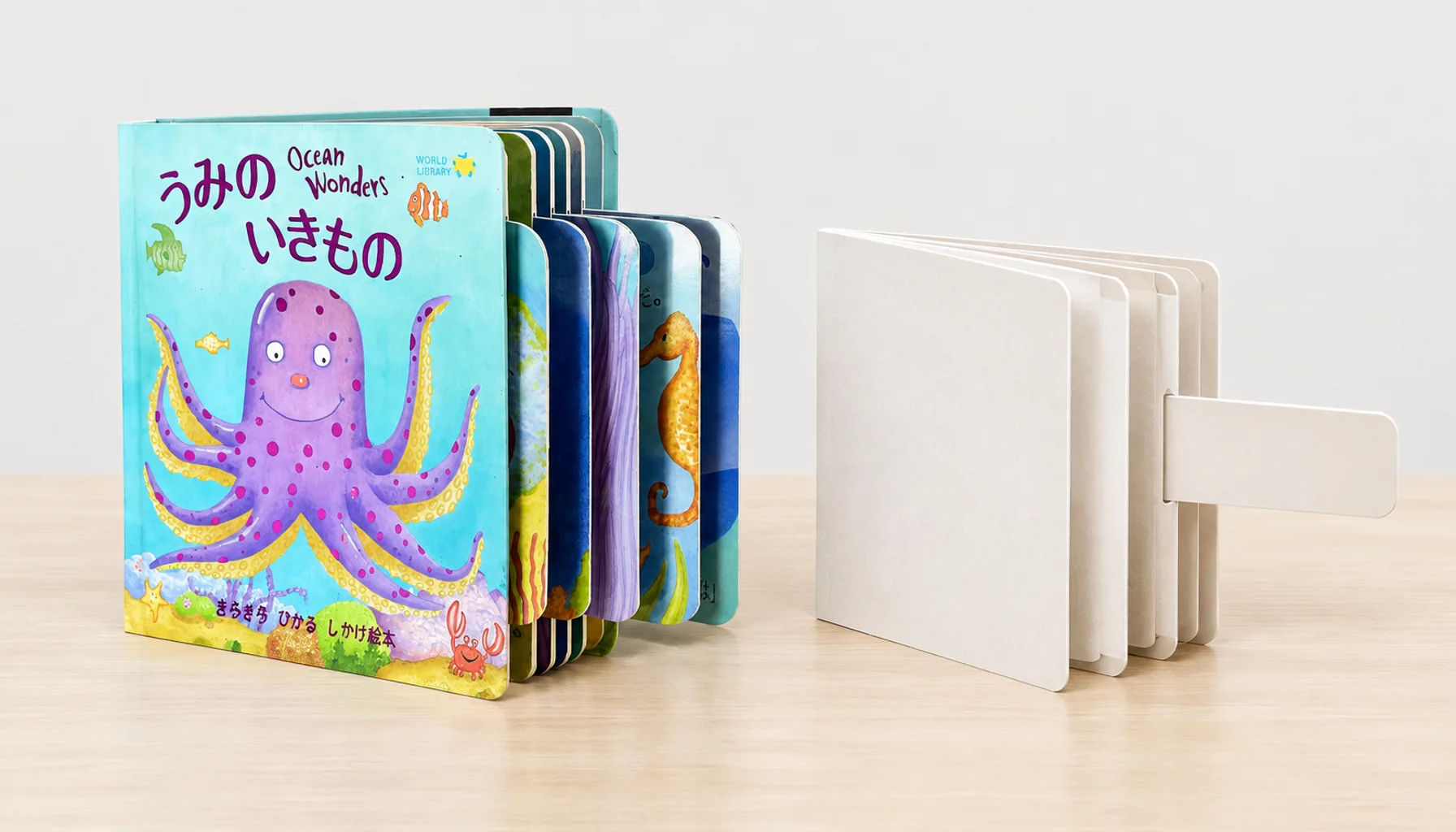 Push-pull board book displayed beside a separate paper pull-tab prototype